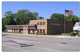 The Security Bank Minnesota building on Bridge Avenue in Albert Lea, a low brick building with a flagpole